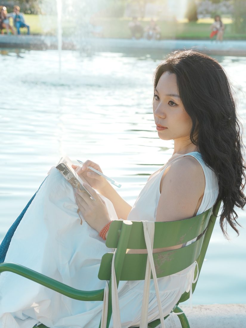 Kaya Li writing by the water